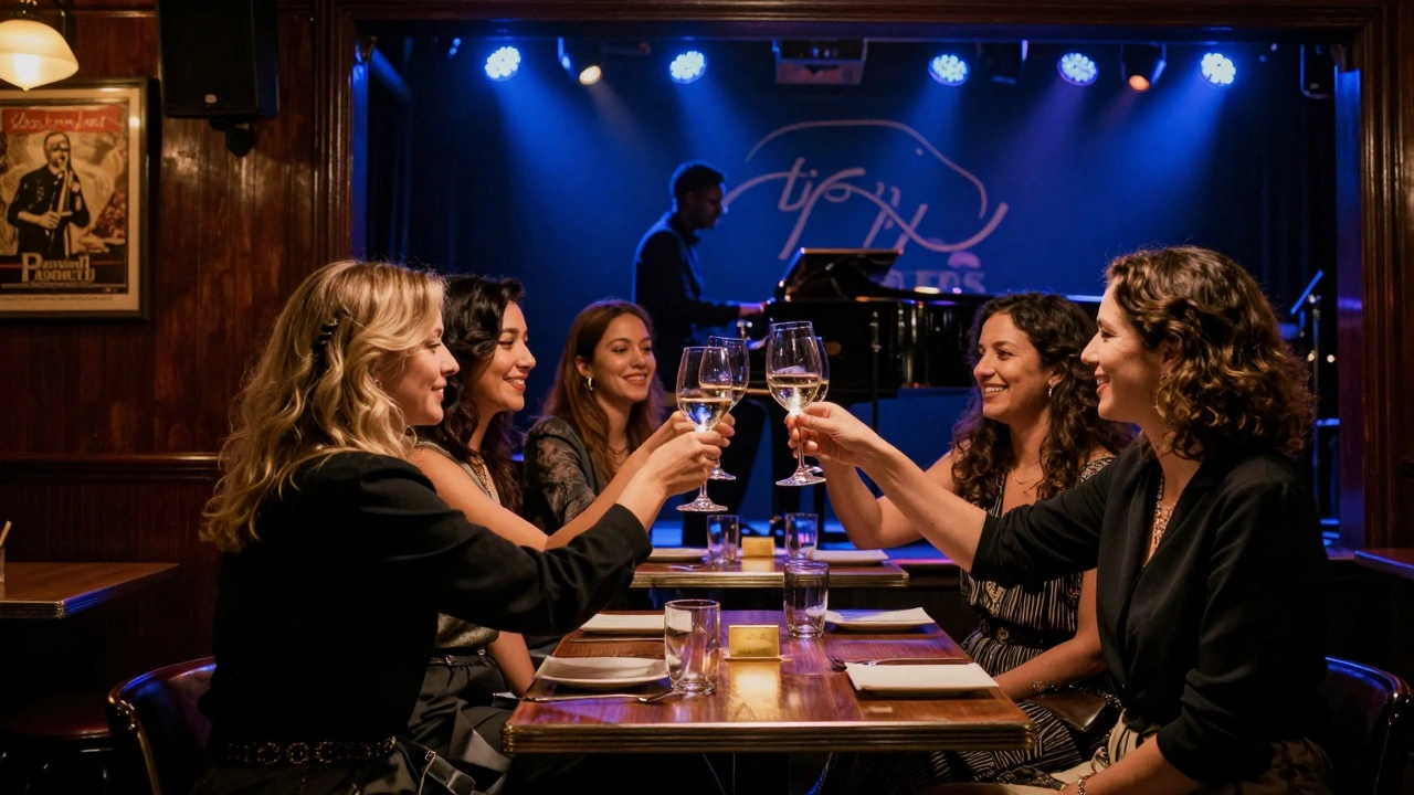 Group of women toasting at a reserved table in Ronnie Scott’s jazz club, stage lights and wood paneling in the background.
