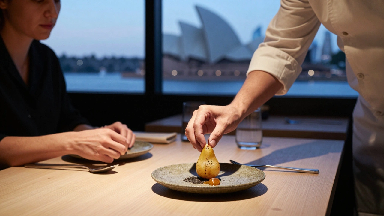 A chef placing a dehydrated pear with black tea salt on a stone plate in a Sydney restaurant.
