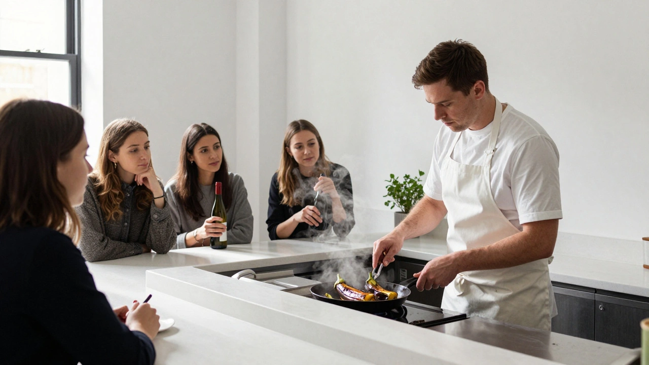 A chef cooking at a counter while women watch, one holding a wine bottle in Clapham.