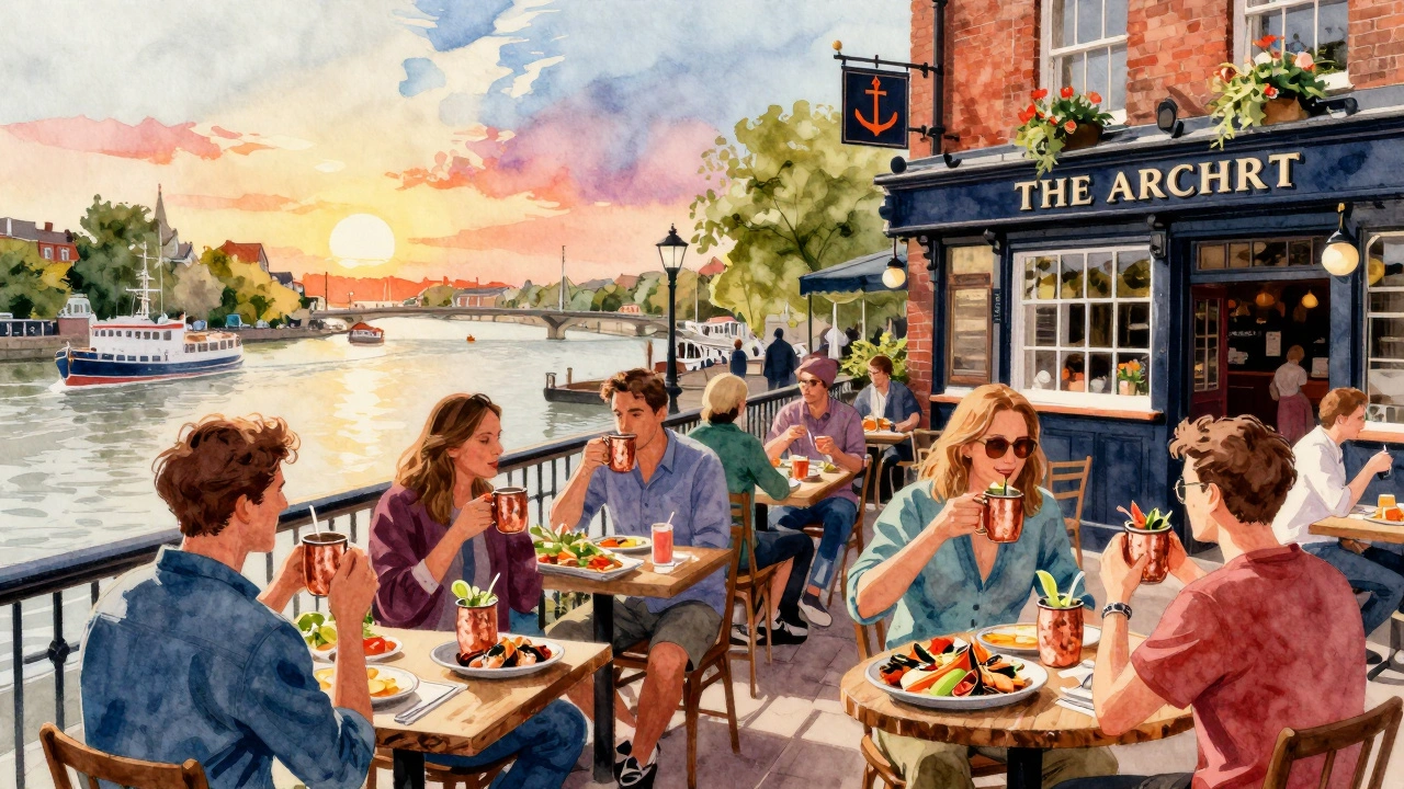 Group sharing seafood platter and copper mugs at riverside pub terrace.