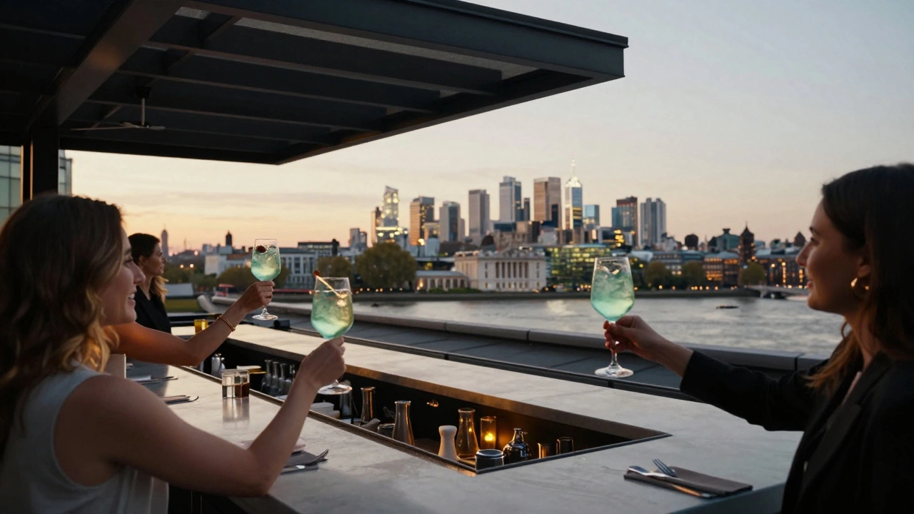 Women celebrating on Greenwich Hotel rooftop with Thames skyline view.
