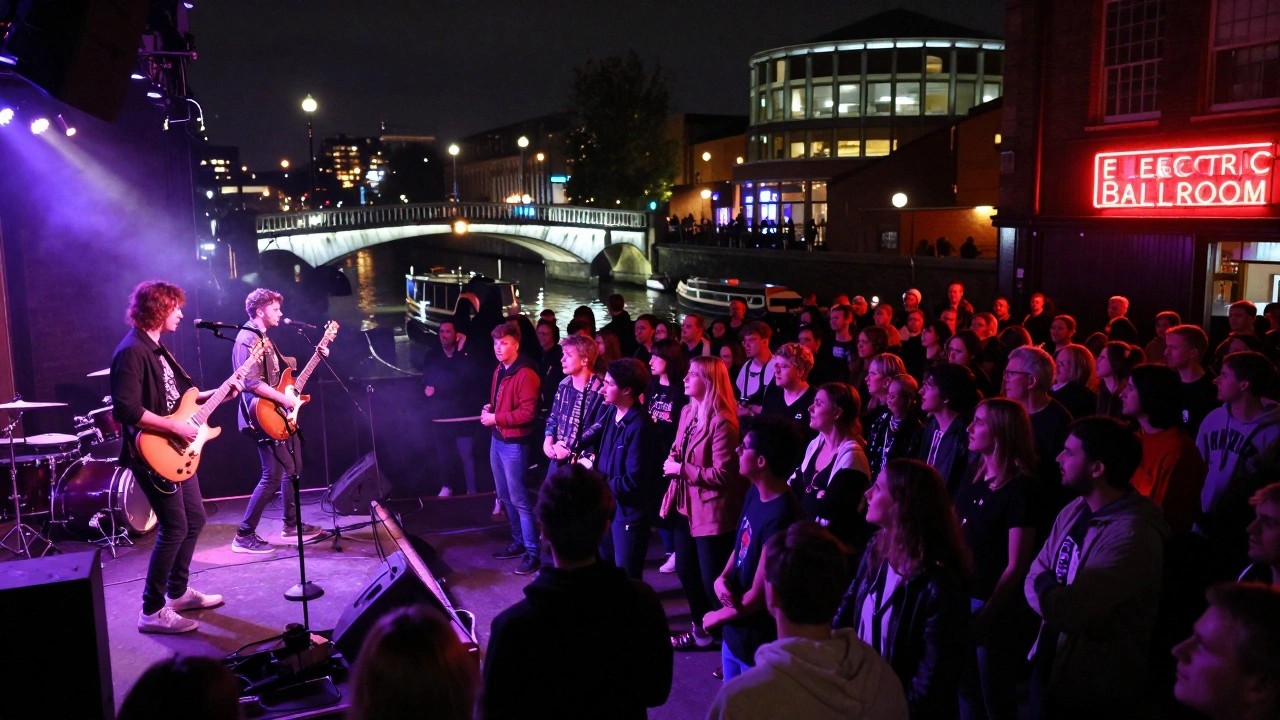 A punk band performs under neon lights at The Electric Ballroom as the crowd sways, with Camden Lock Bridge glowing in the distance.