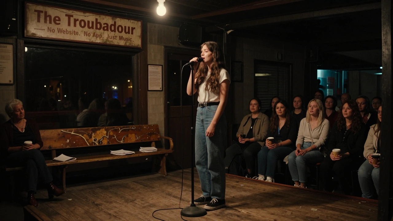 A young singer performs in silence at The Troubadour in 2025, the audience moved by her heartfelt song.