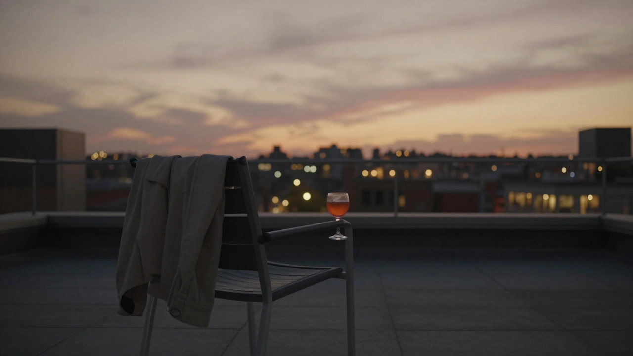 An empty rooftop chair with a cocktail and jacket, overlooking a glowing London skyline at dusk.
