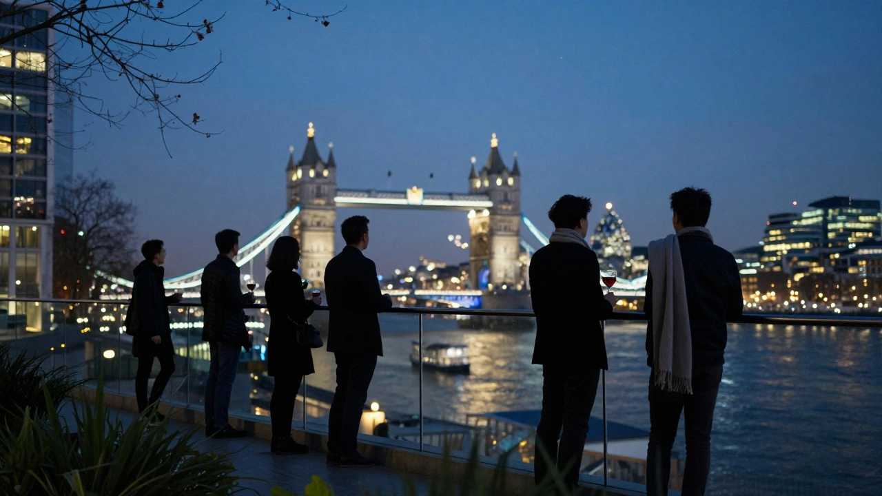 People enjoying nighttime views of London’s skyline from a quiet rooftop garden with cocktails.